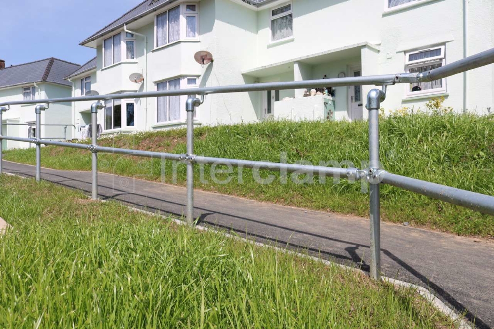 Disability handrails along pedestrian access ramp